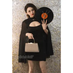 Gynoid June 156cm doll with short dark hair, fair facial styling, and elegant black dress presentation