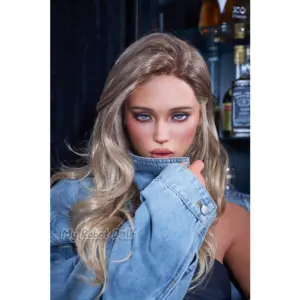 Real Lady R19 Vera Dark Tanned ROS MAX 170cm doll with highlighted waves, blue-gray eyes, and glossy rose lips, pictured in a light blue denim jacket.