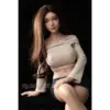 Bc Dolls G02A Qing 76Cm With Very Long Brown Hair, Soft Facial Features, Beige Off-Shoulder Ribbed Crop Top, And Dark Fitted Shorts.