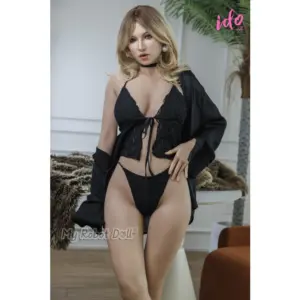 IDo Doll June realistic sex doll with shoulder-length blonde hair, smoky eye makeup, soft pink lips, a full bust, defined waist, and a black lace outfit with matching choker.
