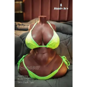 Jiggly Joy Nina 63cm JJ10 torso sex doll with dark tan skin, oversized rounded breasts, defined abdominal contours, wide hips, thick thighs, and a neon green bikini.